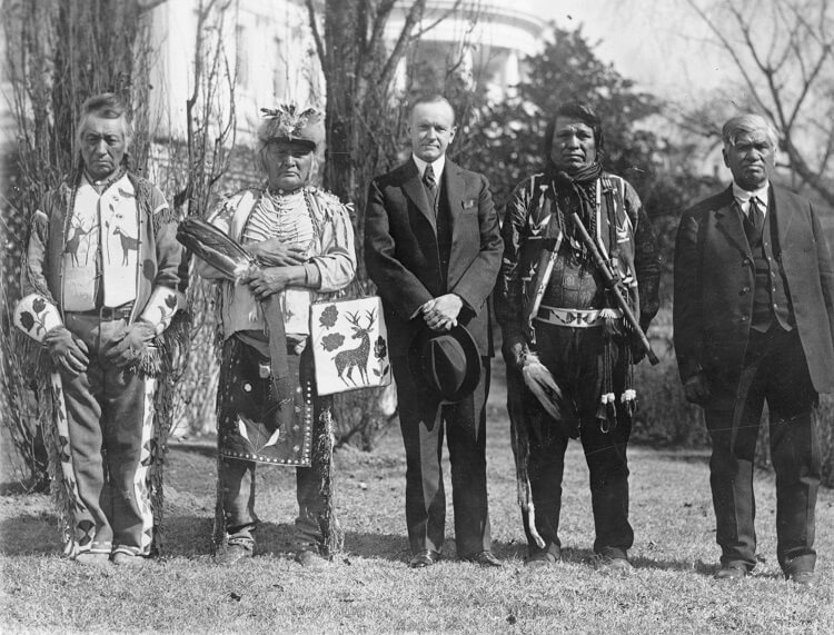 Osage men with Coolidge after he signed the bill granting Native Americans U.S. citizenship